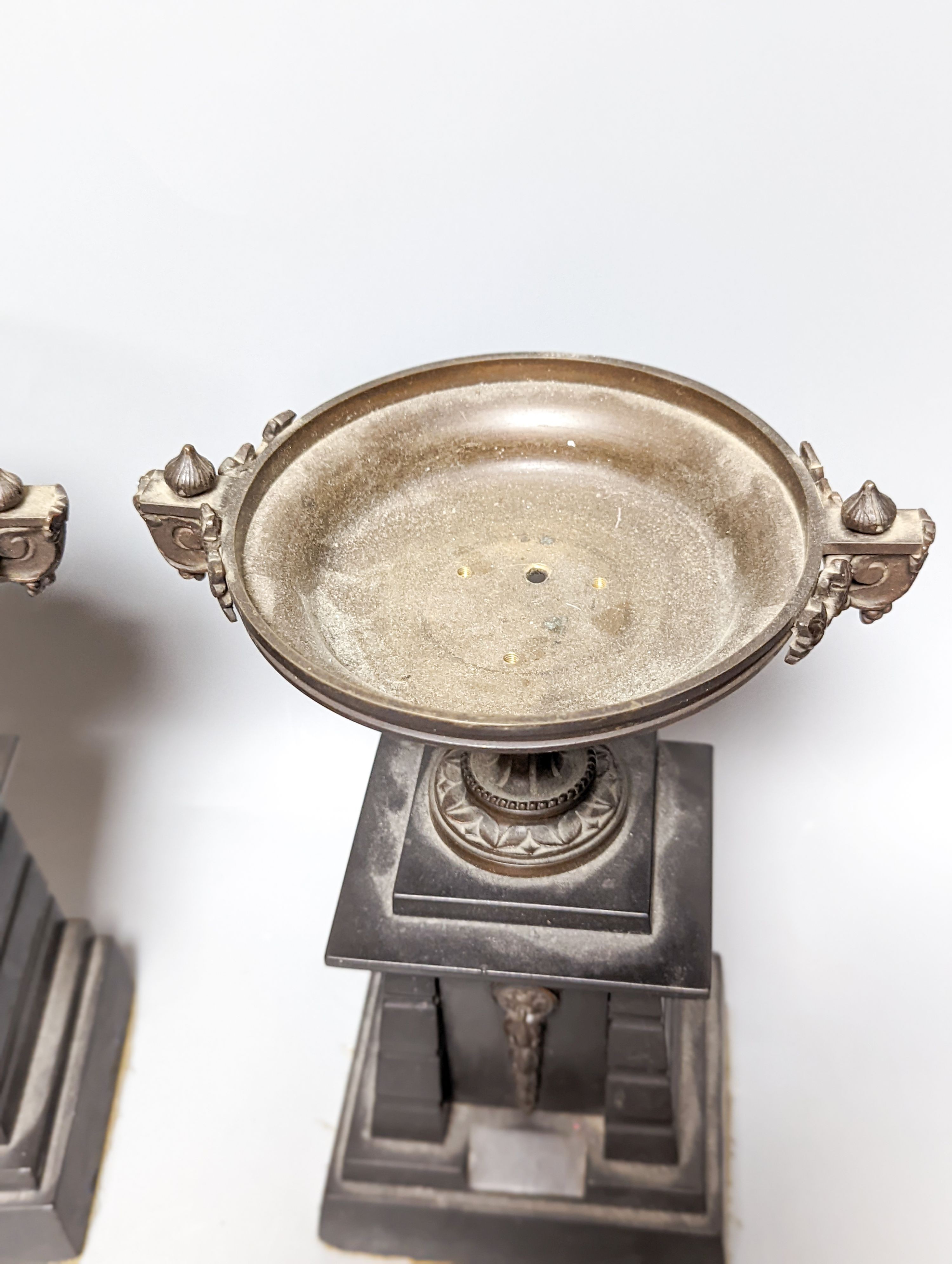 A pair of bronze tazzas on architectural slate bases, c.1900, together with a third, associated piece (3) 25cm